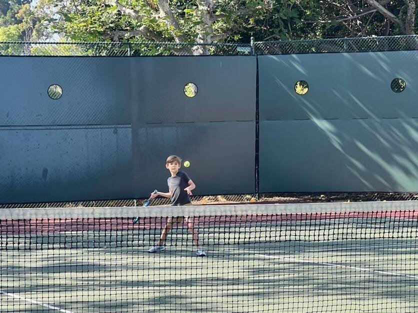 Junior tennis player preparing to hit a ball during groundstroke and rally practice