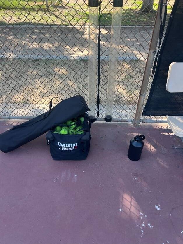 Tennis balls, racket bag and ball pickup tubes ready for private and group tennis lessons in Los Angeles